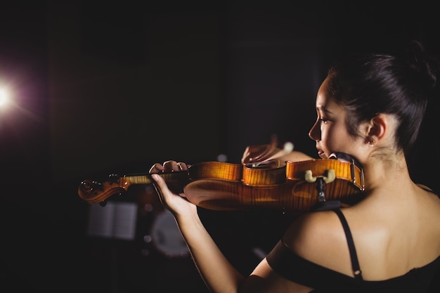 Free photo female student playing violin