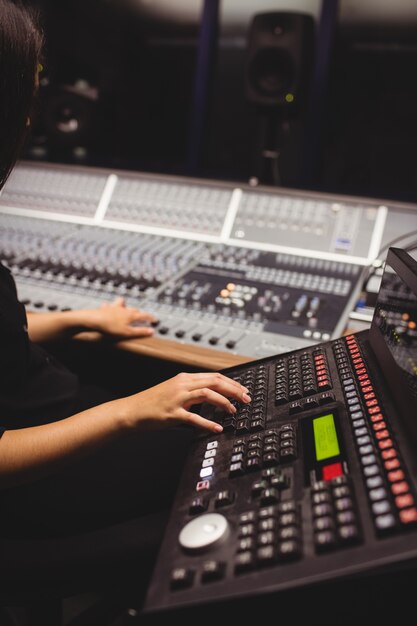 Female student using sound mixer keyboard