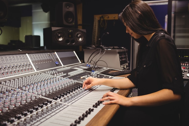 Free photo female student using sound mixer