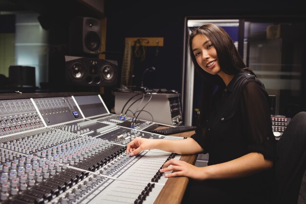 Female student using sound mixer