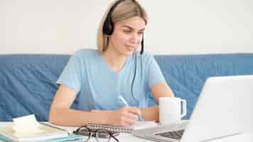 Free photo female student with coffee and laptop