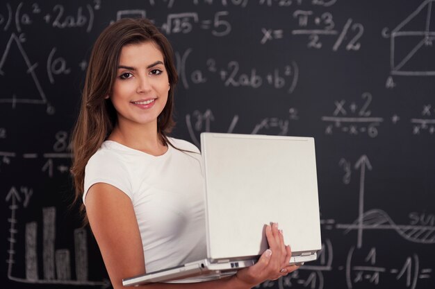 Female student with laptop in her hands 
