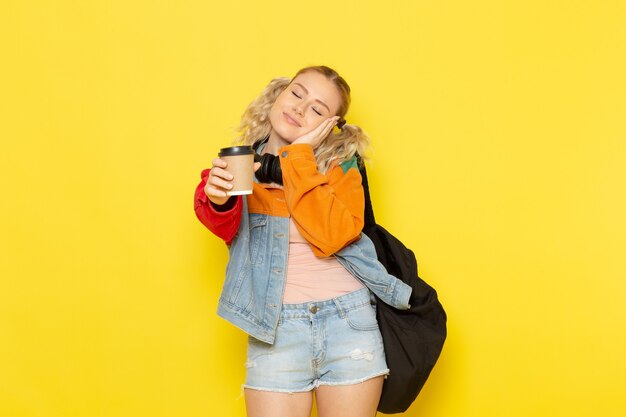 female student young in modern clothes holding coffee desiring to sleep