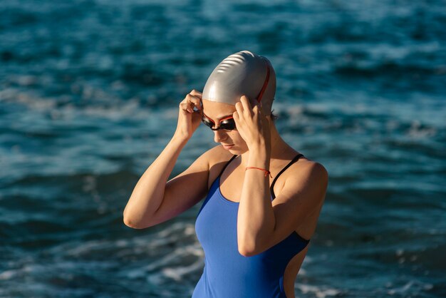 Female swimmer with cap and swimming goggles