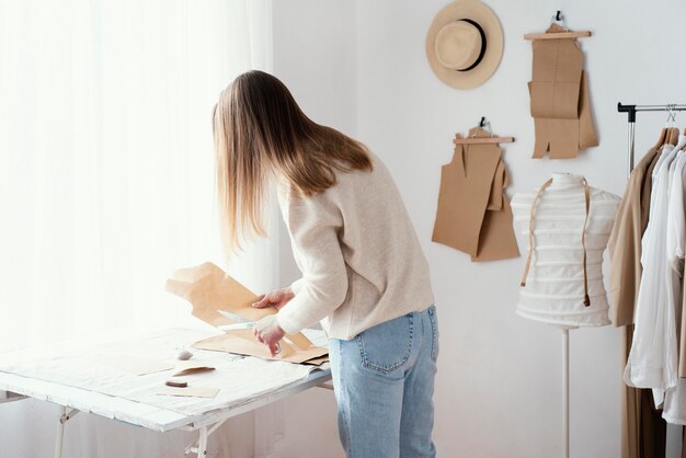 服を着てスタジオで女性の仕立て屋