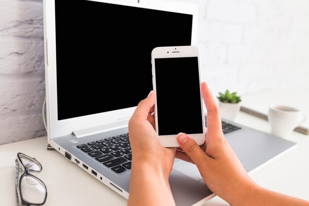 Female taking picture of laptop at home