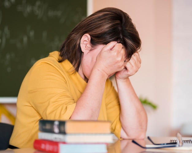 Female teacher at desk tired