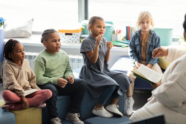 Female teacher reading for her pupils