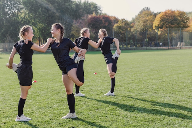 Female team doing warming up exercises