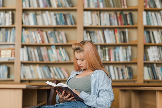 Female teenager enjoying reading
