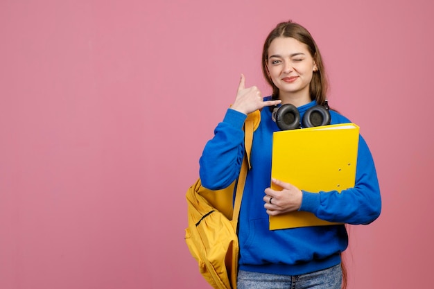 Female teenager standing looking at camera smiling