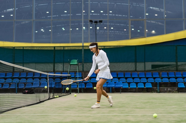 Female tennis player on green court grass