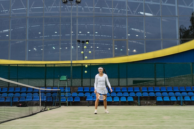 Female tennis player on green court grass