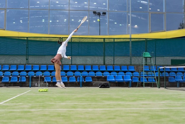 Female tennis player on green court grass