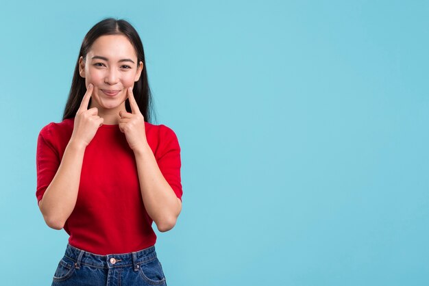 Female touching cheeks with finger