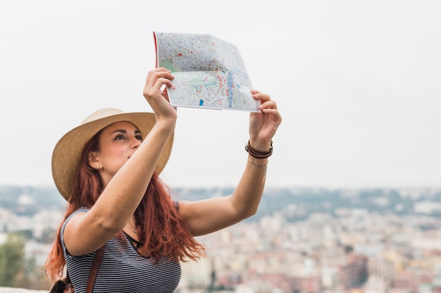 Female tourist looking at map