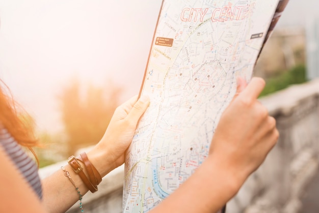 Female tourist looking at map