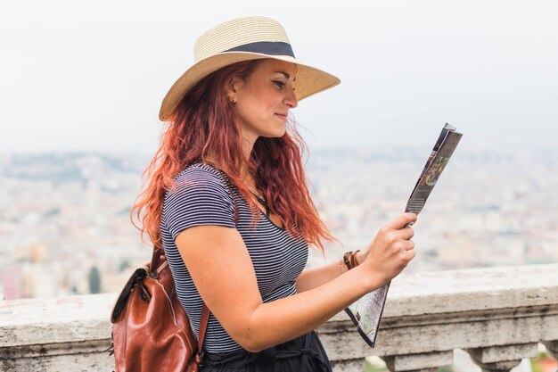 Female tourist looking at map