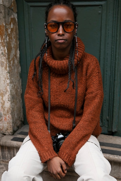 Female tourist posing for portrait of step outdoors