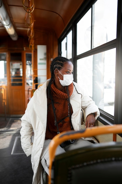 Free photo female tourist with medical mask in the bus