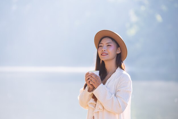 Female tourists are drinking coffee in the morning 