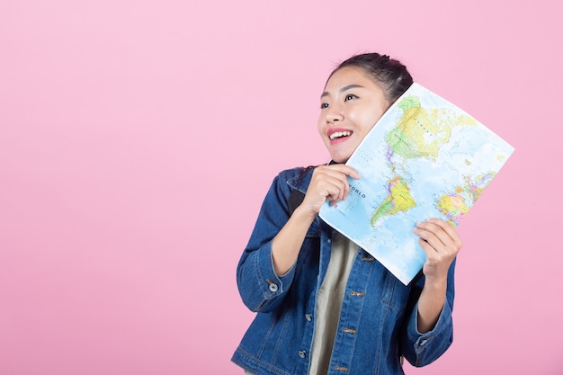 Female tourists in the studio on a pink background.