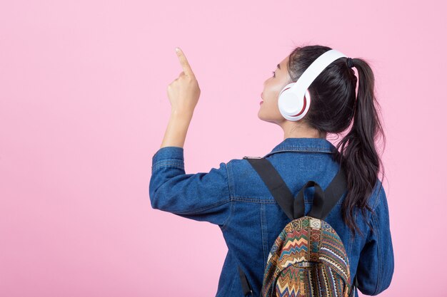 Female tourists in the studio on a pink background.