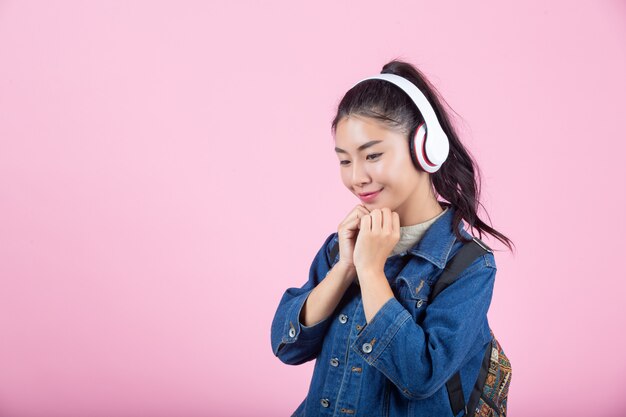 Female tourists in the studio on a pink background.