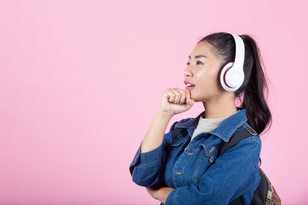 Female tourists in the studio on a pink background.