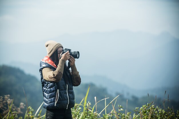 Female tourists take pictures 