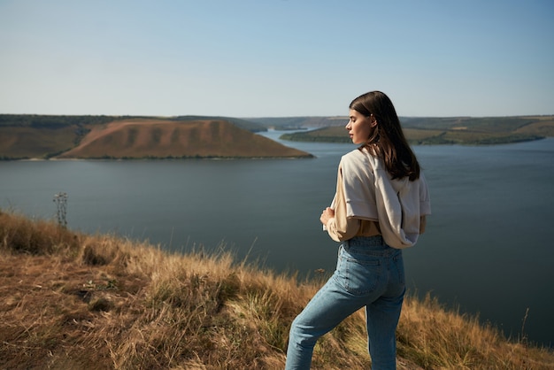 Female traveler standing on edge of rock at bakota bay