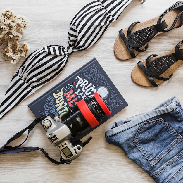 Female travelling accessories with camera and diary on desk