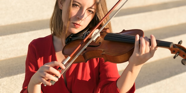 Female violinist playing music on violin