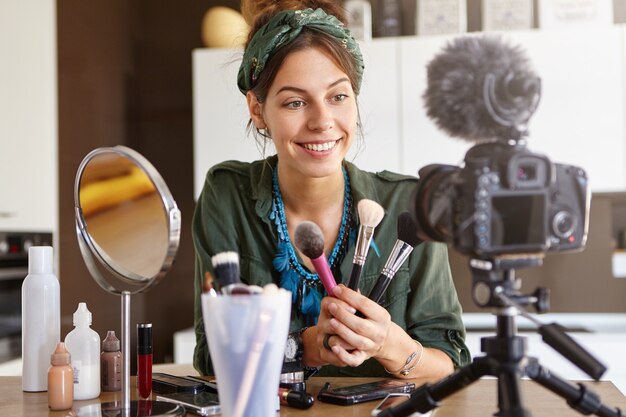 Female vlogger filming makeup video