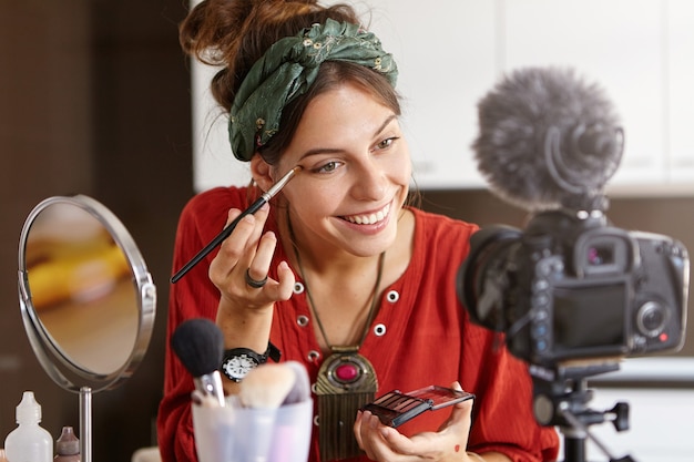 Free photo female vlogger filming makeup video