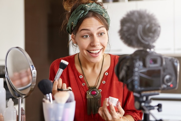 Female vlogger filming makeup video