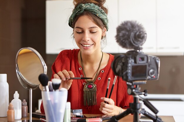 Female vlogger filming makeup video