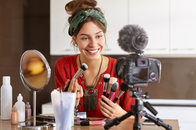 Female vlogger filming makeup video