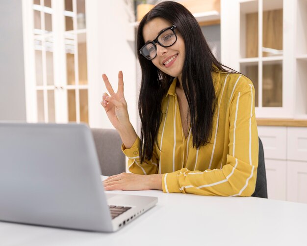 Female vlogger at home with laptop