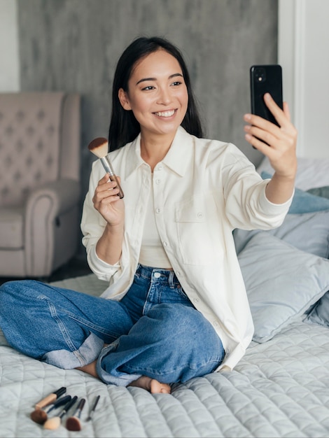 Female vlogger showing her make up brush