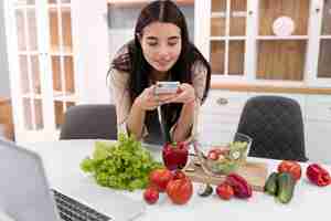 Free photo female vlogger taking pictures with smartphone