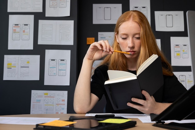 Female web designer in the office with notebook