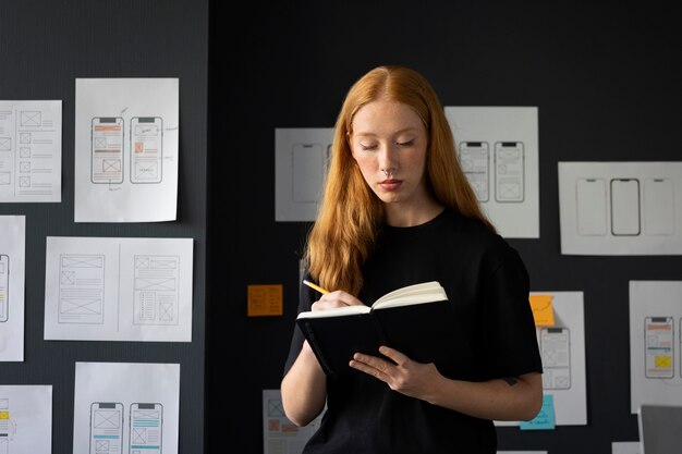 Female web designer in the office with notebook