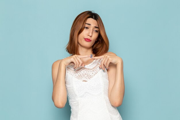female in white dress posing with displeased expression