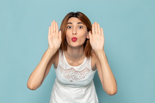 female in white dress posing with funny expressions