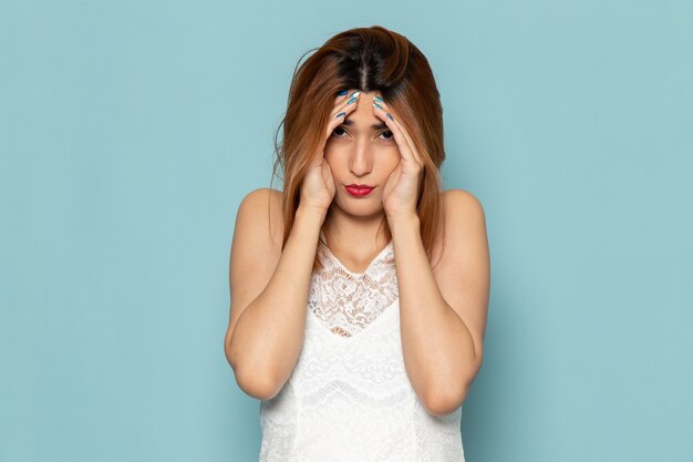 female in white dress with stressed out expression