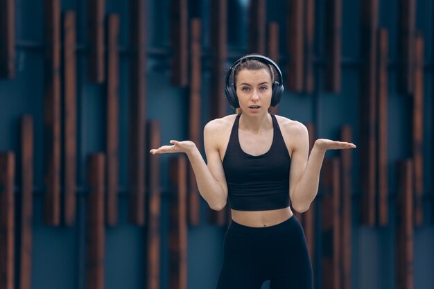 Female with earphones standing annoyed angry disappointed