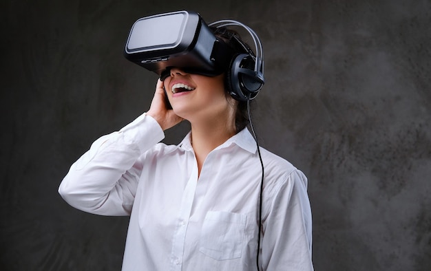 Женщина в очках VR развлекается. Изолированные на сером фоне.