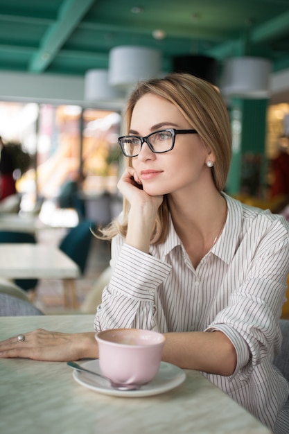 female woman shop alone daydreaming