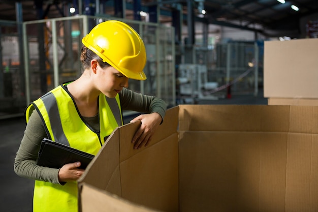 Female worker checking products at warehouse